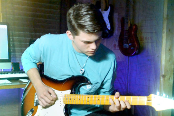 kaleb playing neon on guitar